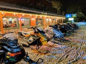 snowmobiles in front of restaurant