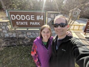 man and woman at state park sign
