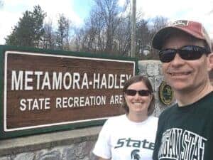 woman and man in front of state park sign