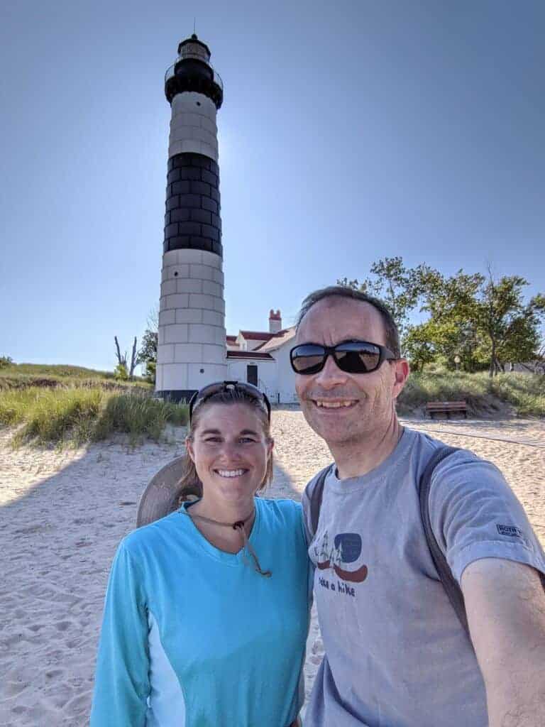 Two people by the Big Sable Point Lighthouse at Ludington State Park