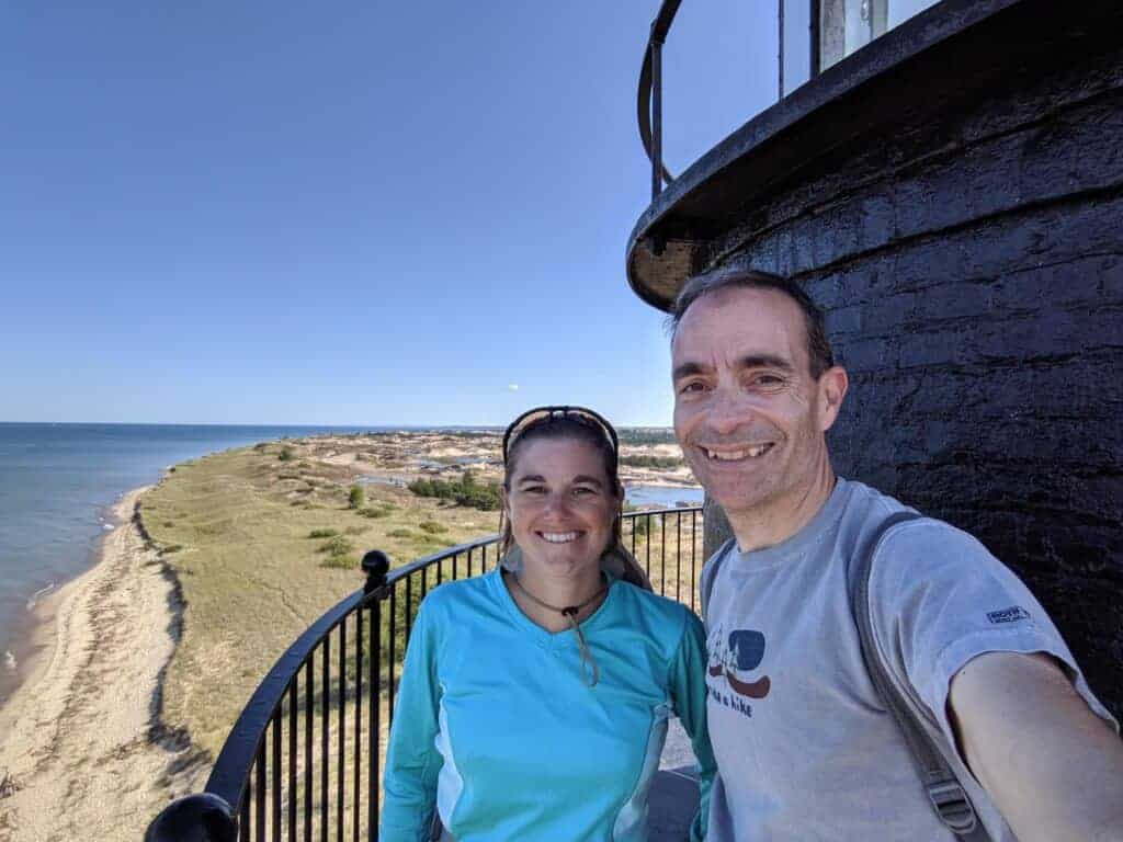 Two people by Big Sable Point Lighthouse at Ludington State Park