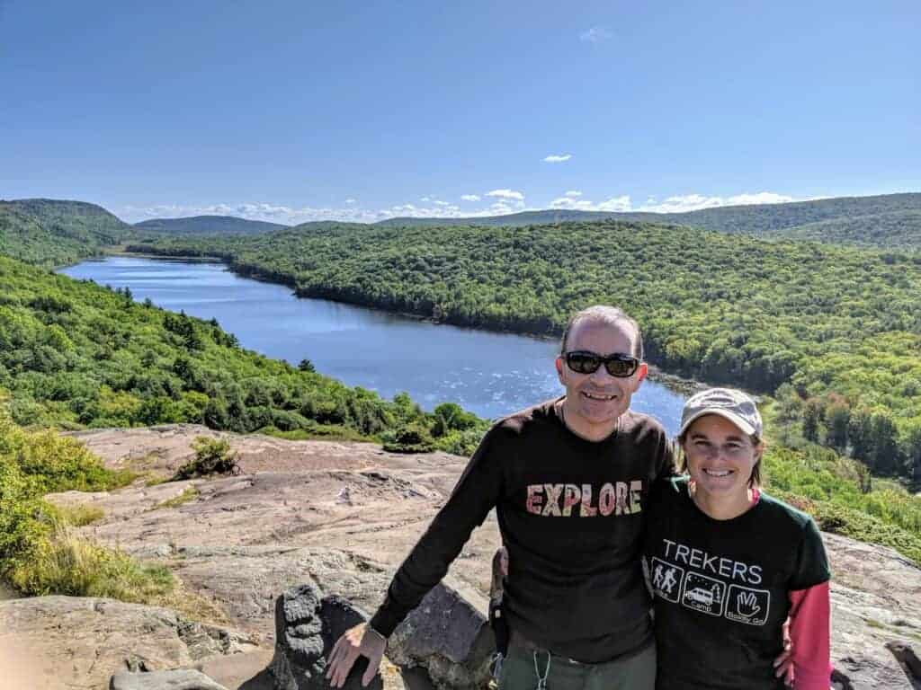 A man and woman standing in front of a lake at Porcupine Mountains Wilderness State Park
