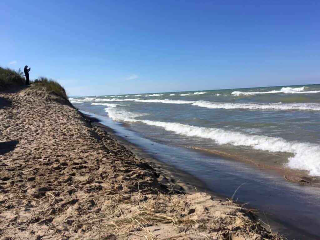 A sandy beach and waves on a lake